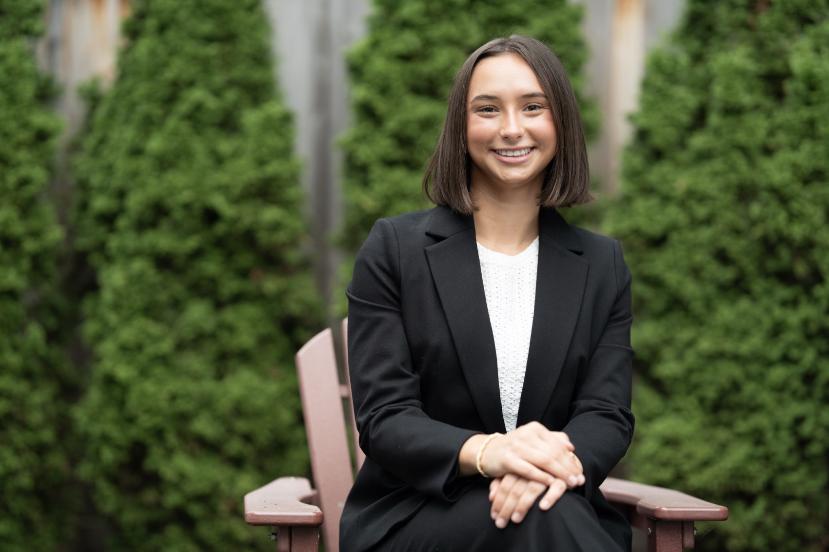 Clean professional headshot of a college senior in a black blazer