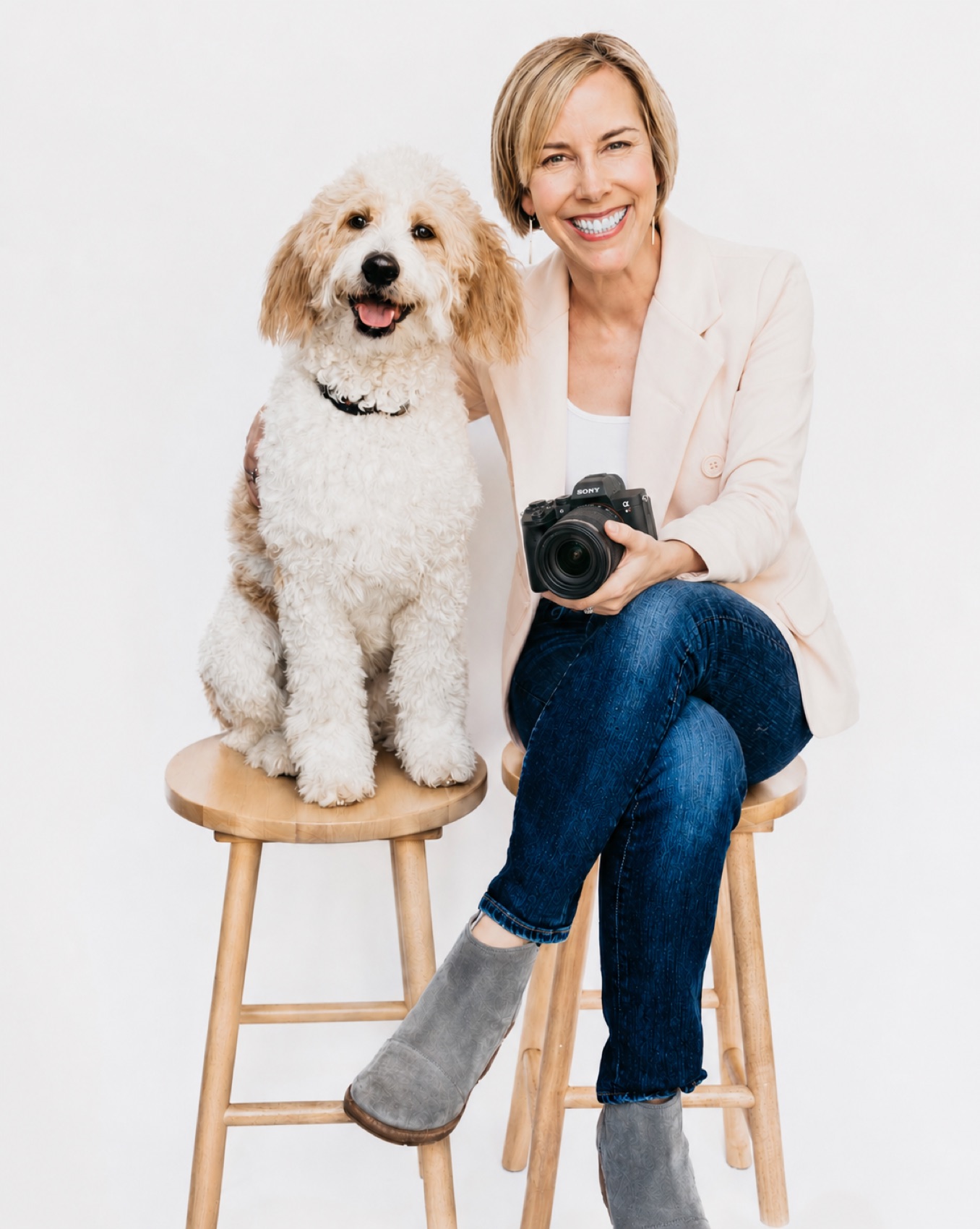 KC Danzansky, senior portrait photographer, with her goldendoodle and camera